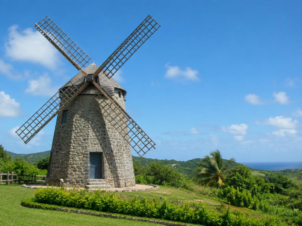 Historic stone sugar mill in green countryside